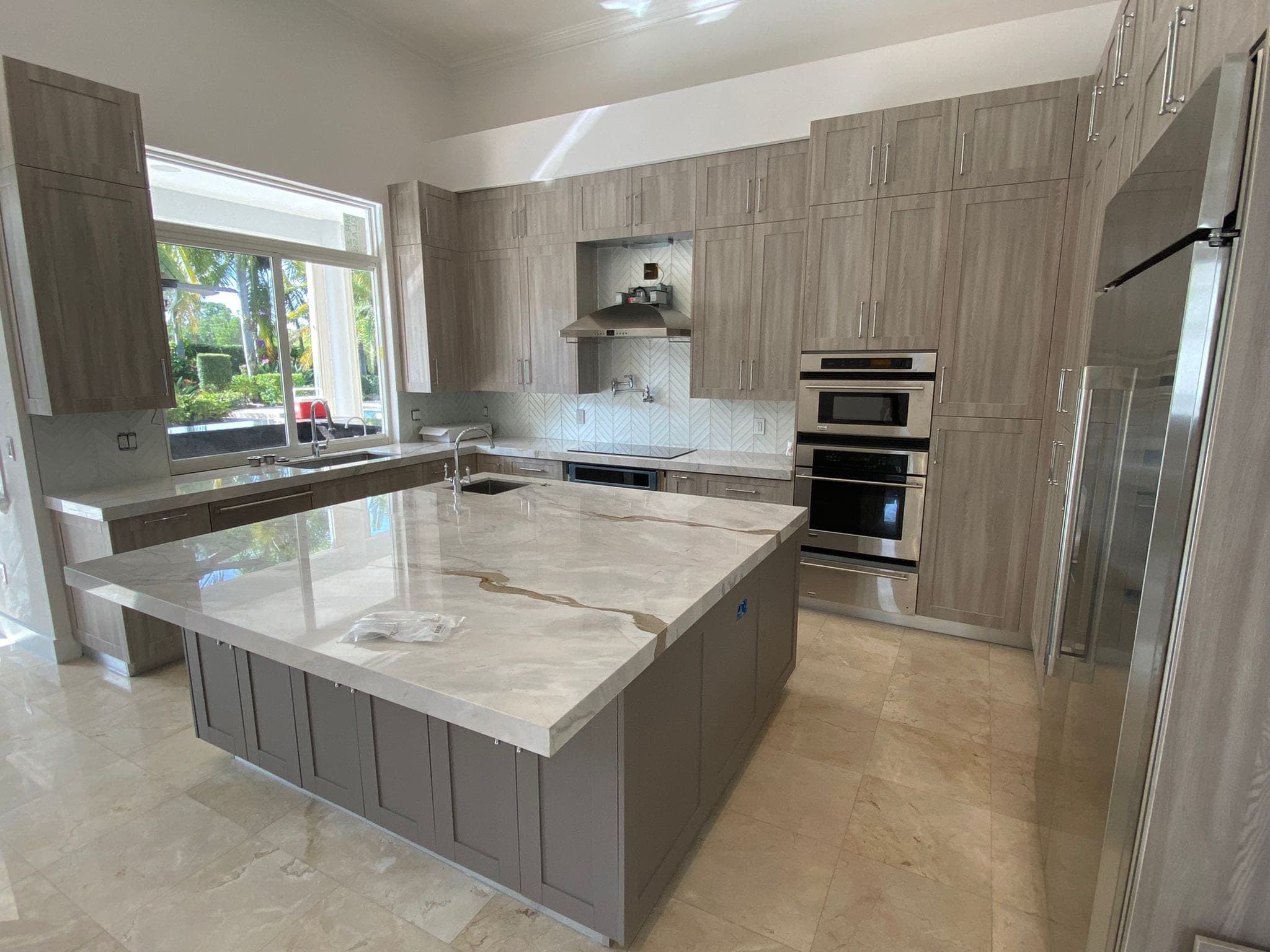 Modern kitchen renovation showcasing custom cabinets and island